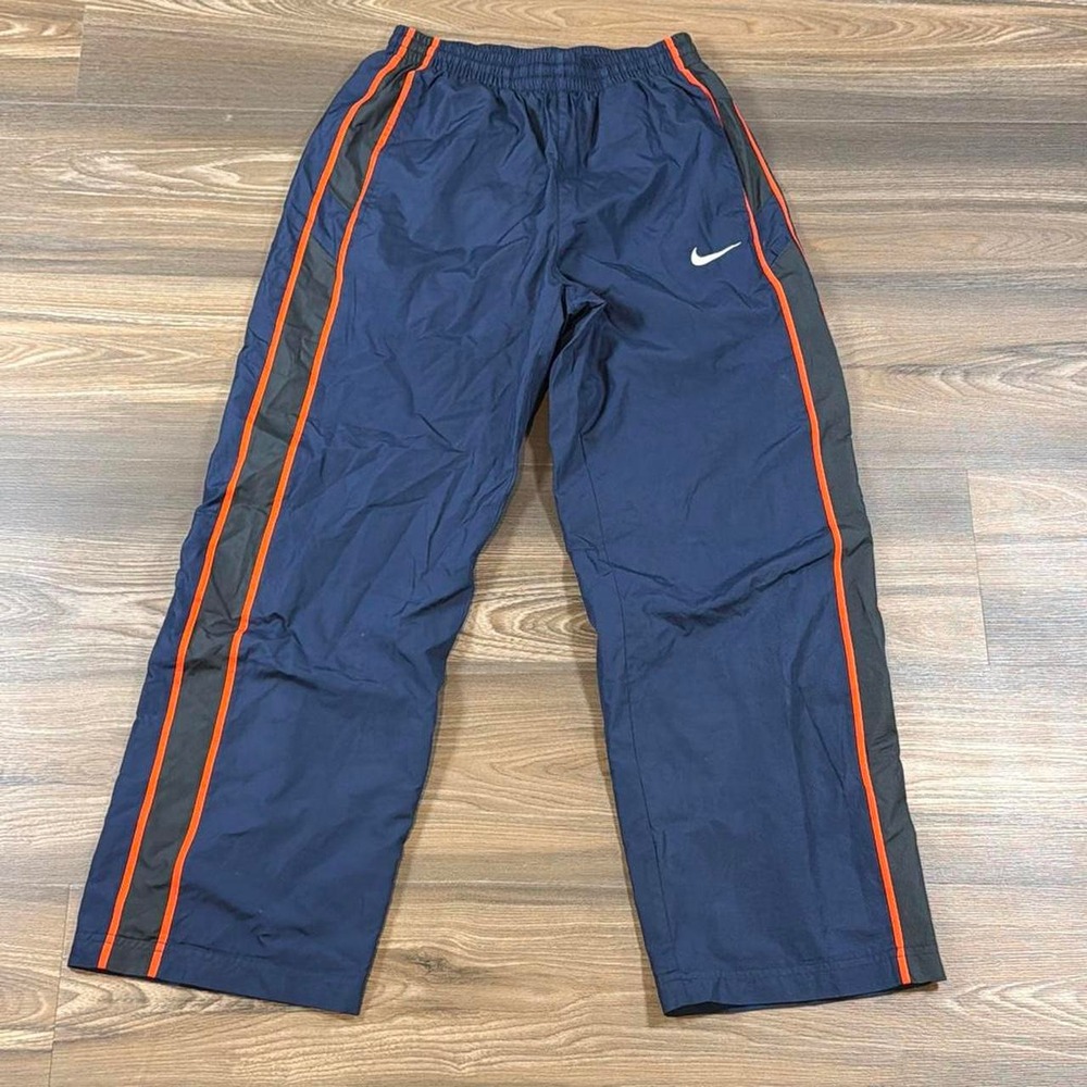 Nike navy blue track pants with orange and gray stripes down the sides, size L